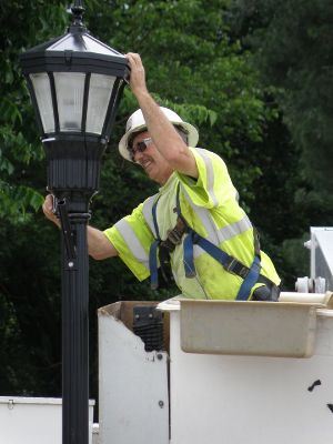 Public Works Repairing a Street Lamp